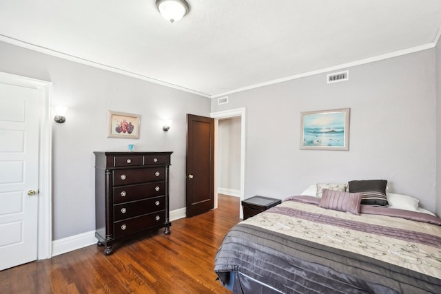 bedroom featuring ornamental molding and dark wood-type flooring