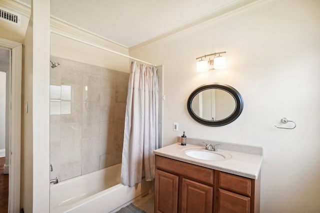 bathroom with crown molding, shower / bath combo with shower curtain, and vanity