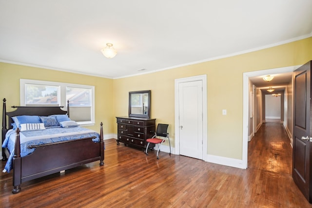 bedroom with crown molding and dark hardwood / wood-style floors