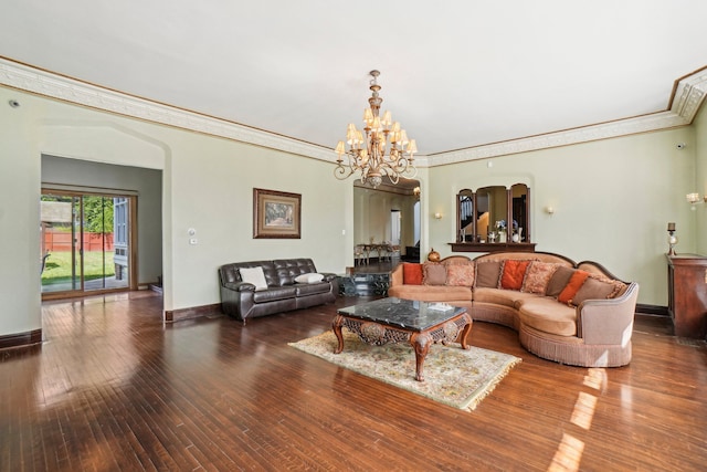 living room with hardwood / wood-style flooring, crown molding, and a chandelier