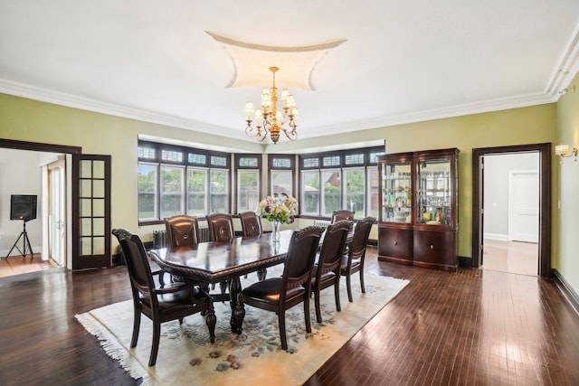 dining area featuring ornamental molding, french doors, dark wood-type flooring, and a notable chandelier