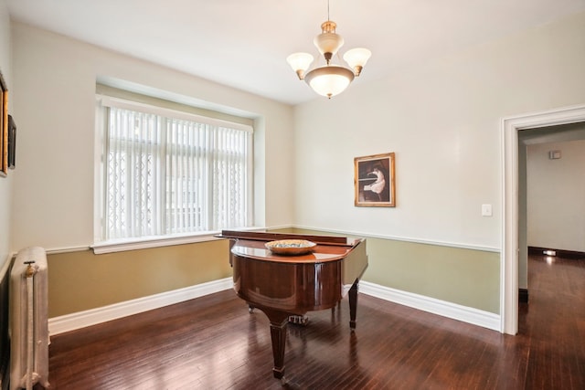 miscellaneous room with radiator heating unit, dark hardwood / wood-style floors, and an inviting chandelier