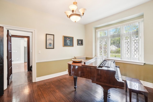 miscellaneous room featuring hardwood / wood-style floors and a notable chandelier