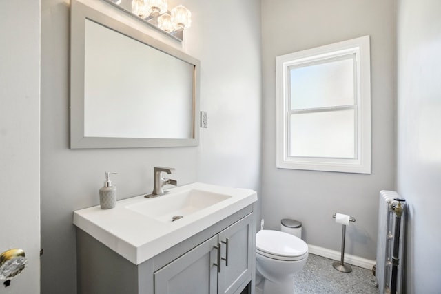 bathroom featuring radiator, vanity, and toilet