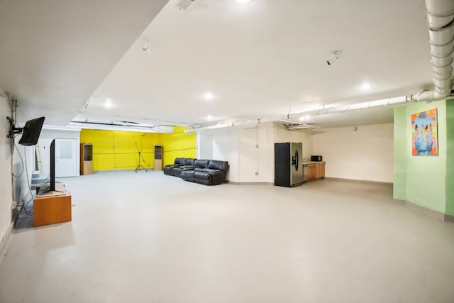 basement with stainless steel fridge