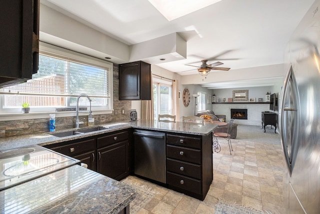 kitchen featuring ceiling fan, sink, stainless steel appliances, kitchen peninsula, and dark brown cabinets