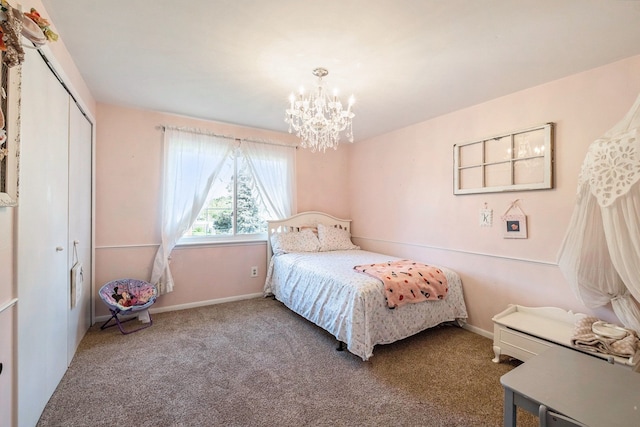 bedroom featuring a closet, carpet floors, and an inviting chandelier