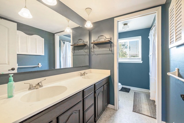 bathroom featuring vanity and toilet