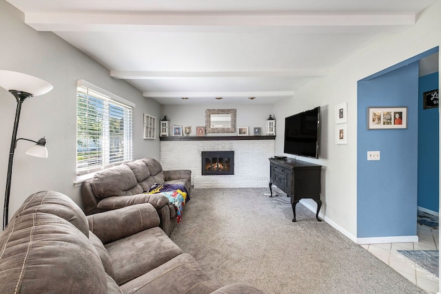 carpeted living room featuring beamed ceiling and a brick fireplace