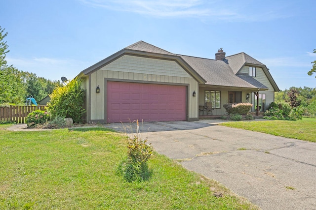 view of front facade featuring covered porch, a garage, and a front yard