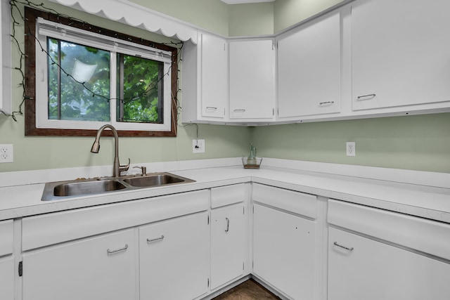 kitchen featuring sink and white cabinets