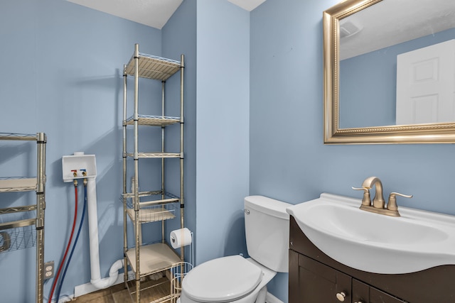 bathroom featuring hardwood / wood-style flooring, vanity, and toilet