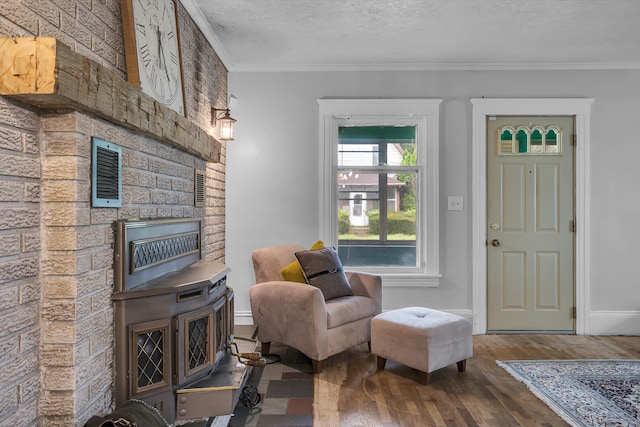 sitting room featuring crown molding, hardwood / wood-style floors, and a textured ceiling