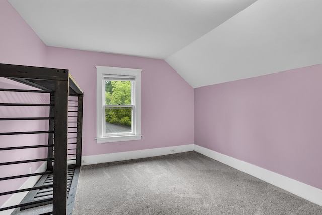 bonus room featuring carpet and vaulted ceiling