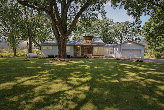 single story home with a garage and a front lawn