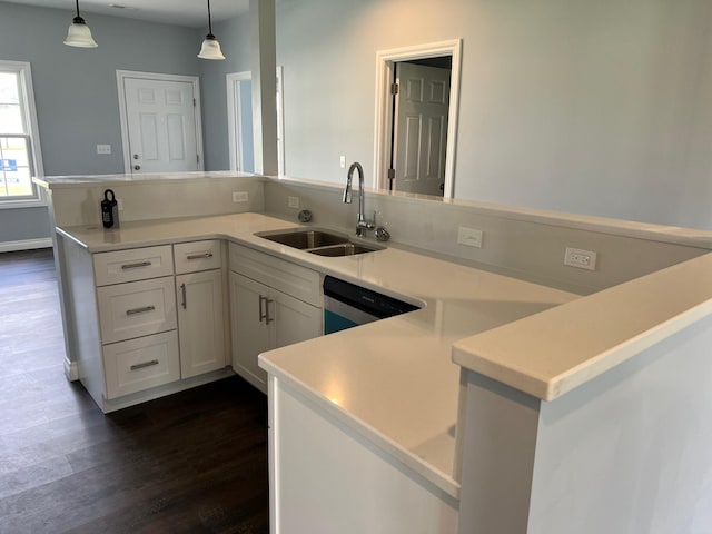 kitchen featuring white cabinetry, sink, dishwasher, dark hardwood / wood-style flooring, and decorative light fixtures