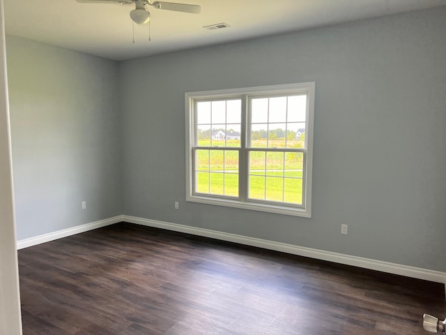 spare room with ceiling fan and dark wood-type flooring