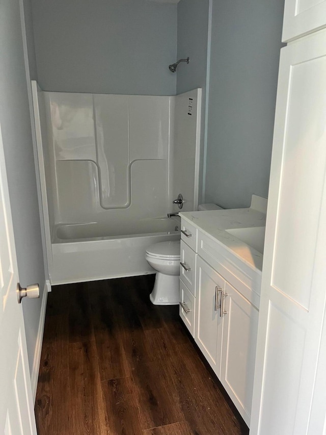 full bathroom with vanity,  shower combination, toilet, and wood-type flooring