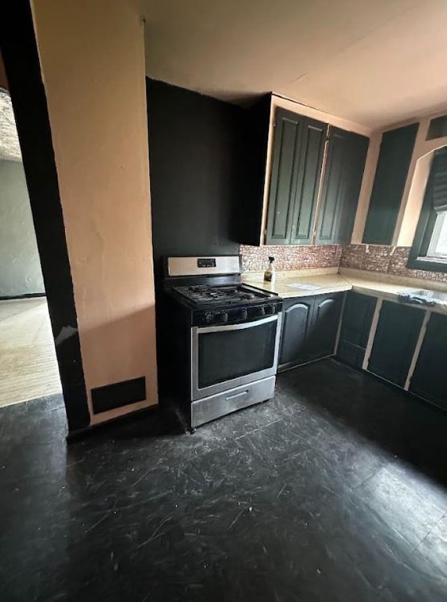 kitchen featuring stainless steel range and decorative backsplash