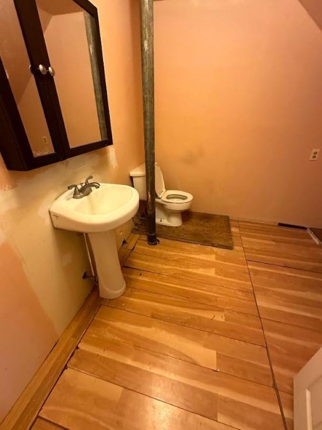 bathroom featuring toilet and hardwood / wood-style flooring