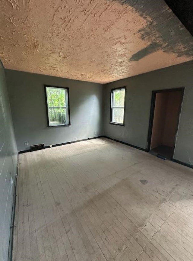 unfurnished room with light hardwood / wood-style floors