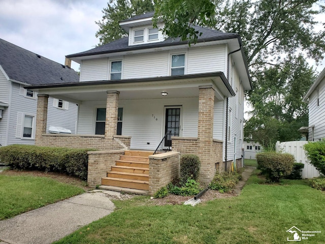 view of front of house featuring a porch and a front lawn