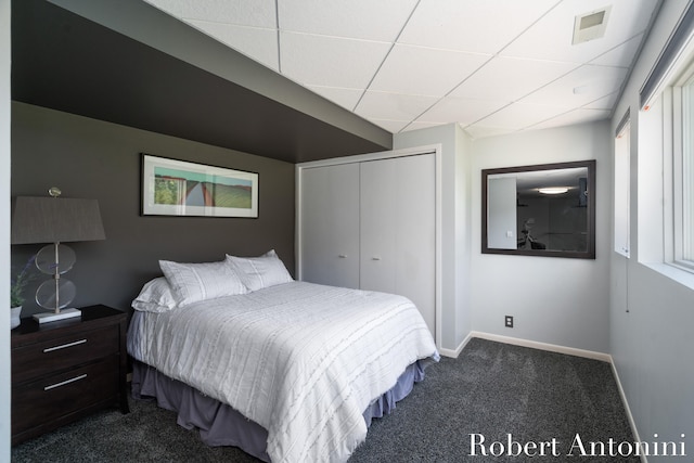 bedroom with a closet and dark carpet