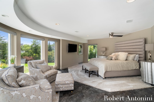 bedroom featuring ceiling fan and multiple windows