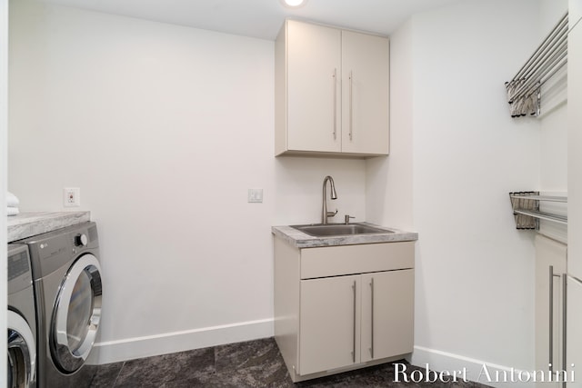 clothes washing area with sink, cabinets, and independent washer and dryer