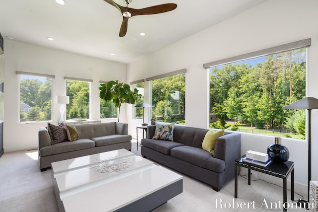 living room featuring light colored carpet and ceiling fan