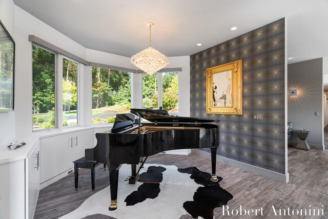 miscellaneous room featuring a chandelier and wood-type flooring