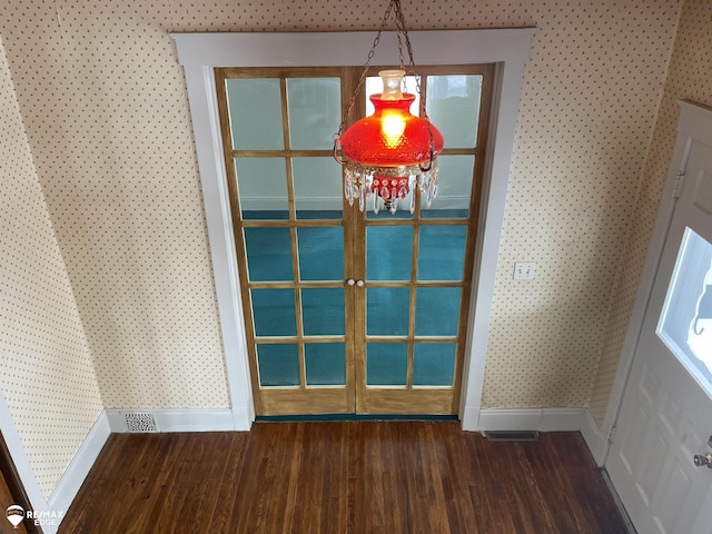 unfurnished dining area with dark wood-type flooring