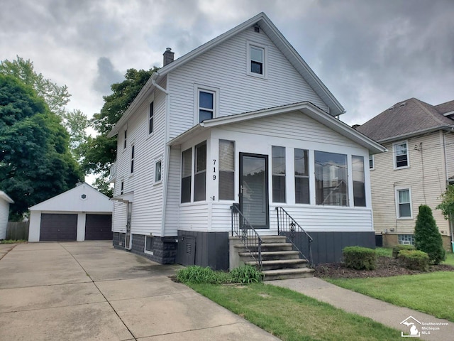 view of front of house with a garage and an outdoor structure