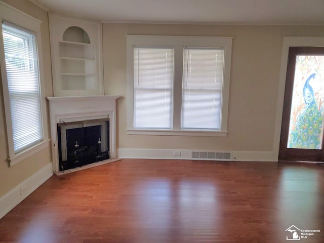 unfurnished living room featuring wood-type flooring