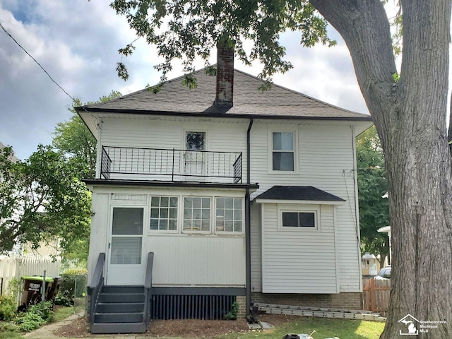 rear view of property featuring a balcony