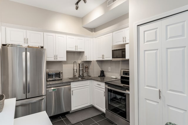 kitchen featuring white cabinets, sink, and stainless steel appliances