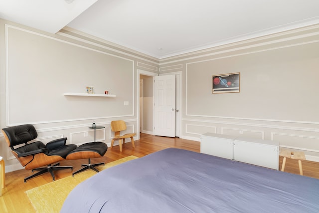 bedroom featuring light wood-type flooring and ornamental molding