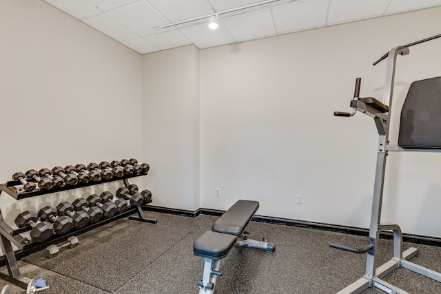 exercise room with a paneled ceiling