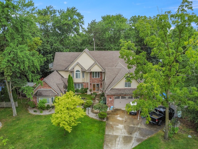 view of front of home with a garage and a front lawn