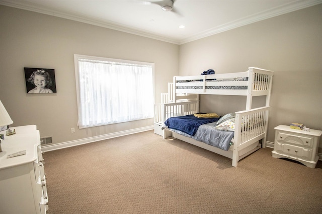 carpeted bedroom with ceiling fan and ornamental molding