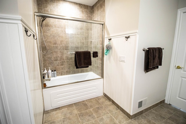 bathroom with bath / shower combo with glass door