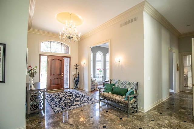 foyer entrance featuring a chandelier and ornamental molding