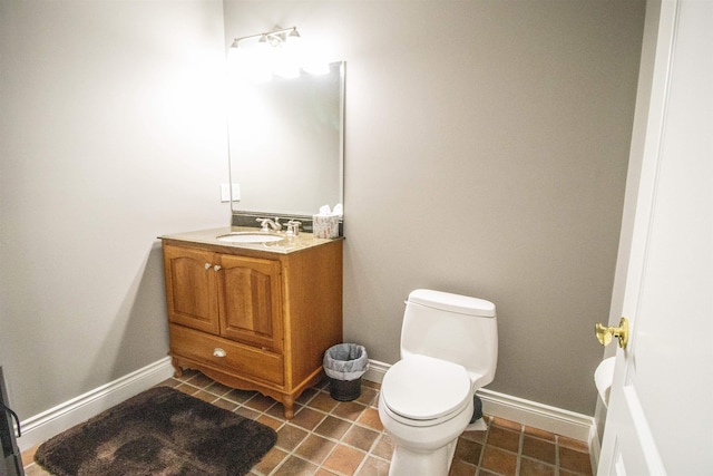 bathroom with tile patterned floors, vanity, and toilet