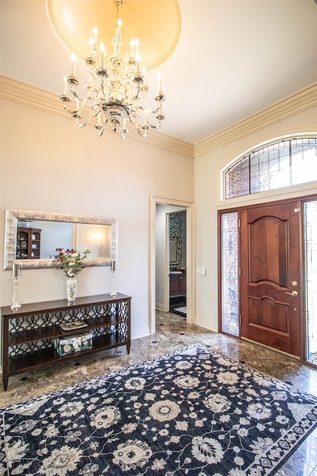 foyer entrance featuring ornamental molding and a chandelier