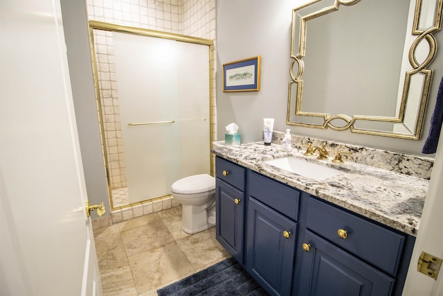 bathroom with vanity, an enclosed shower, and toilet