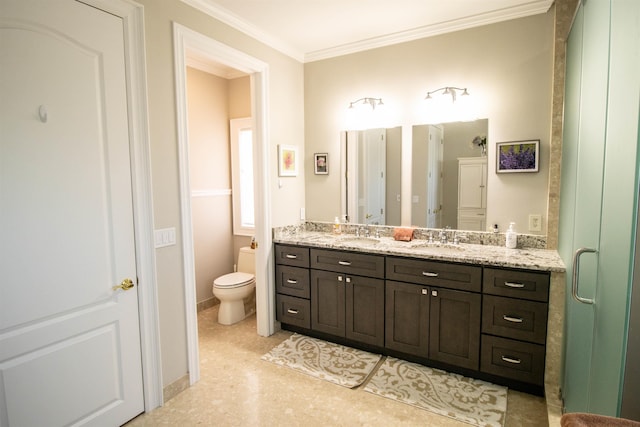 bathroom with vanity, toilet, a shower with shower door, and crown molding