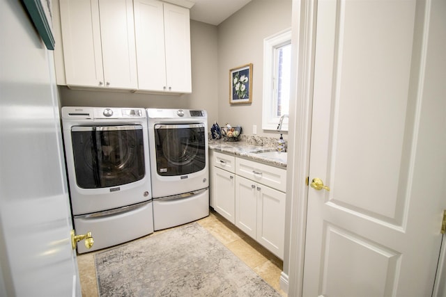 laundry room with cabinets, independent washer and dryer, light tile patterned flooring, and sink