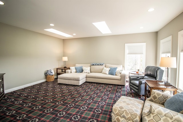 living room with carpet flooring and a skylight