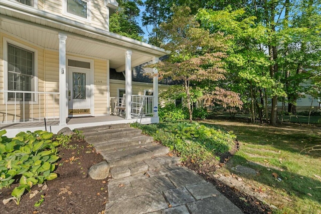 view of exterior entry with a porch