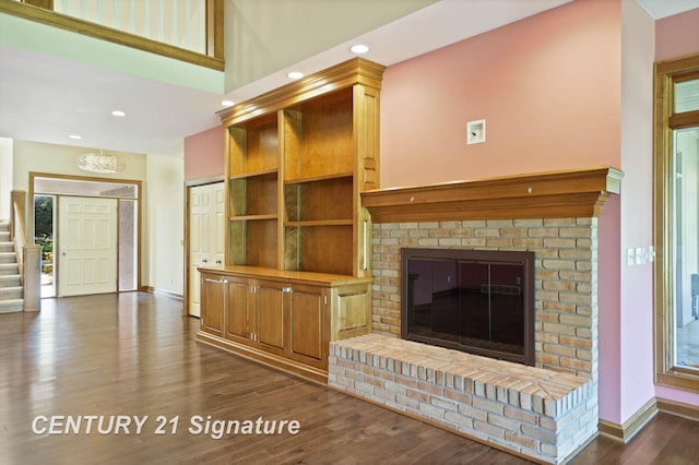 unfurnished living room with a fireplace and dark hardwood / wood-style flooring